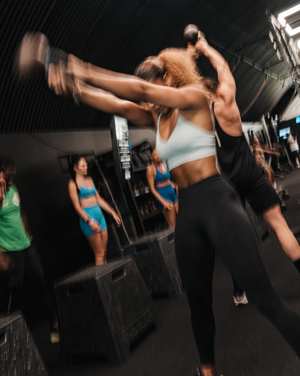 The coach lifting weights at the gym.